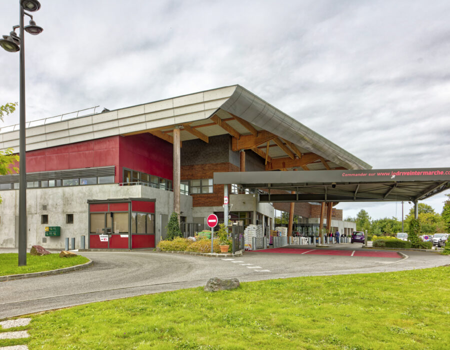 Façade rouge en béton et en bois de l'Intermarché de Saint-Julien-sur-Sarthe 